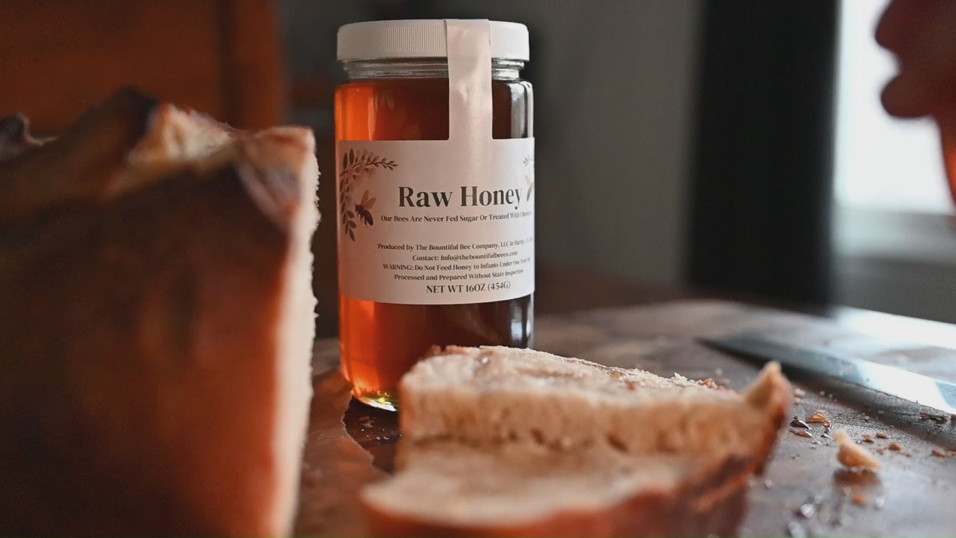 Load video: Raw Local Honey drizzling on fresh baked bread